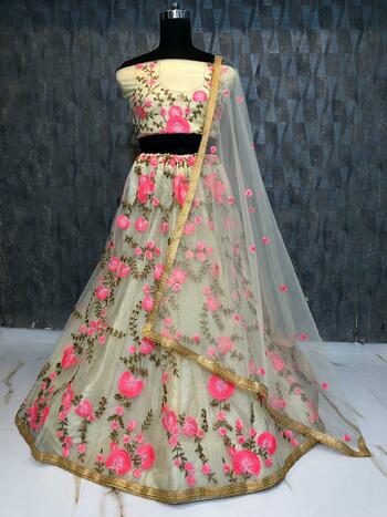 Appealing Cream Color Soft Net Embroidered Stone Work Lehenga Choli For Party Wear